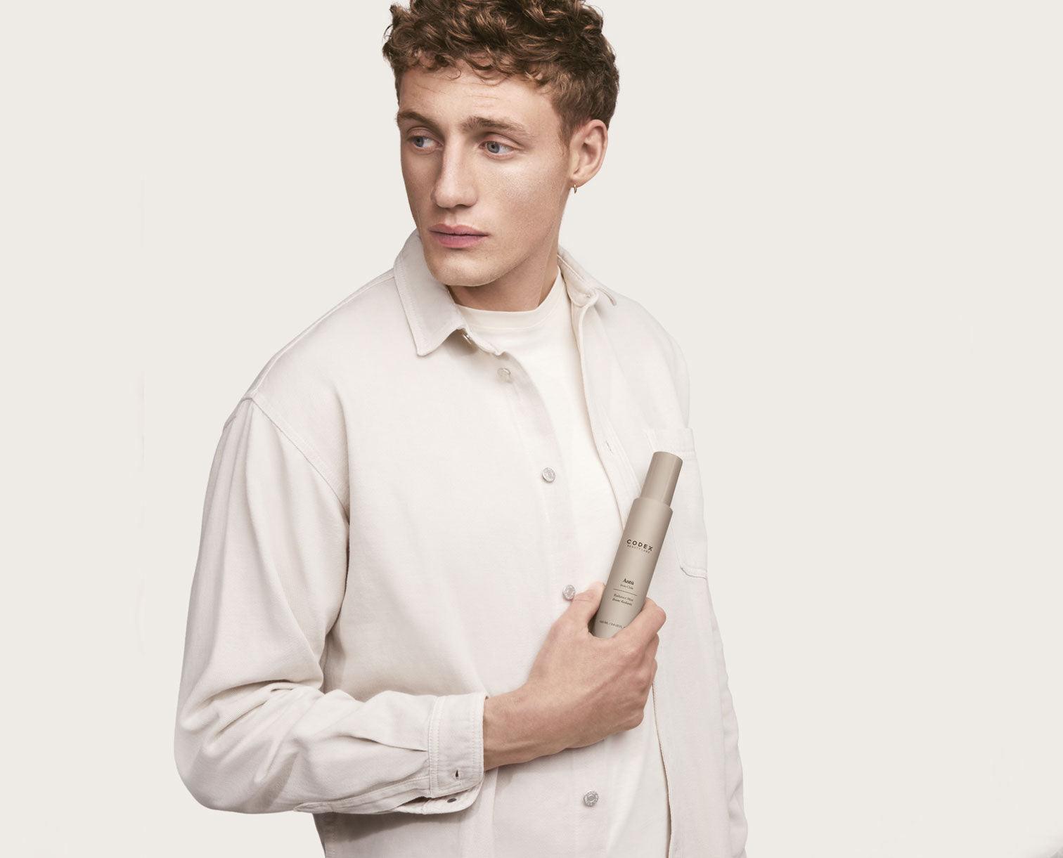 Image of male Codex Beauty Labs model holding an Antu Radiance Mist