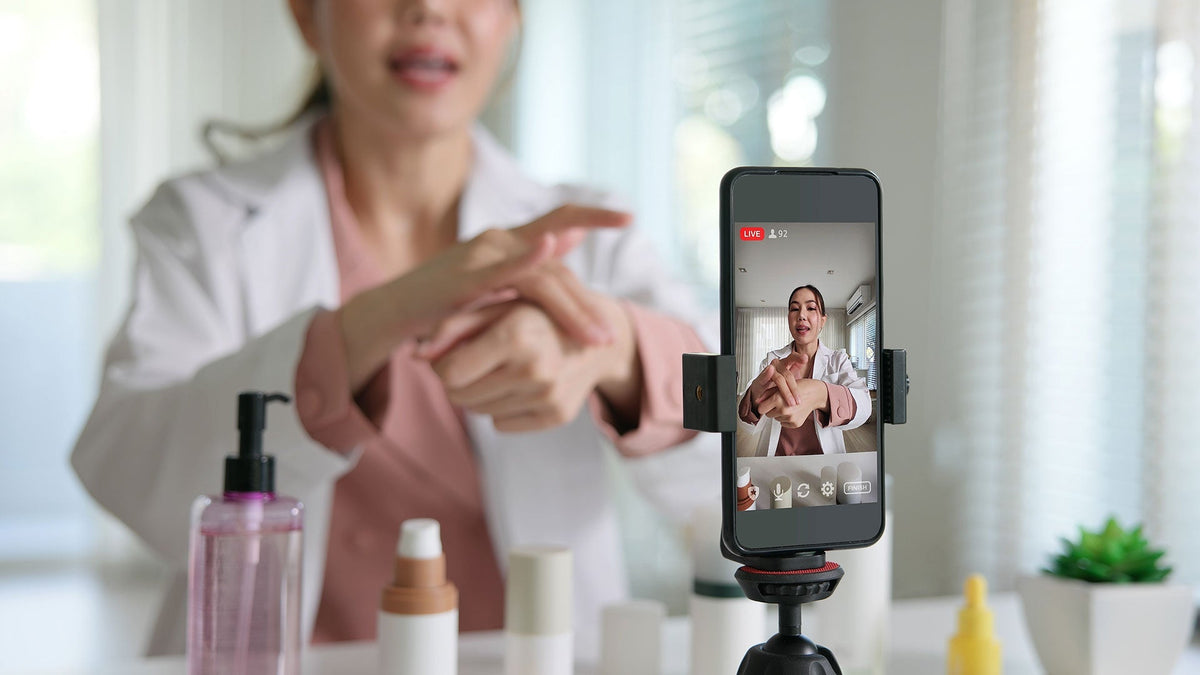 Dermotologist with a smart phone recording putting on a  topical