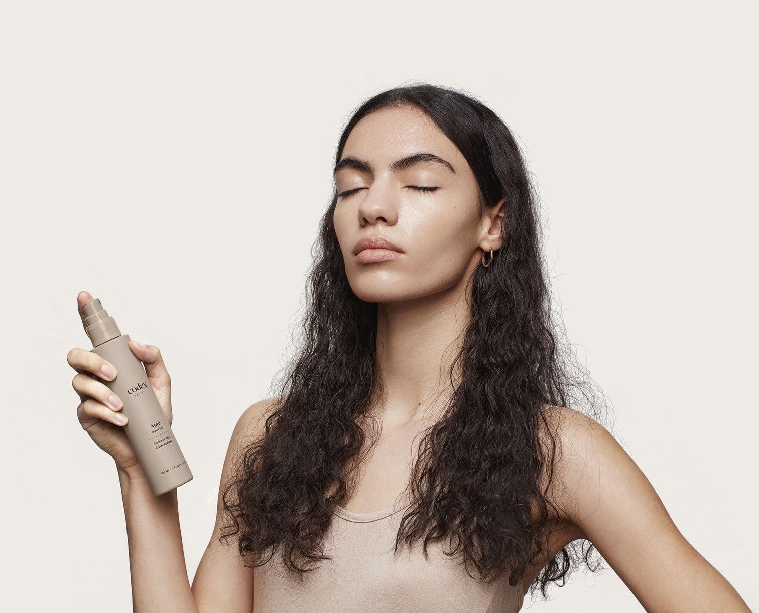 Codex Beauty Labs model using the Antu Radiance Mist.