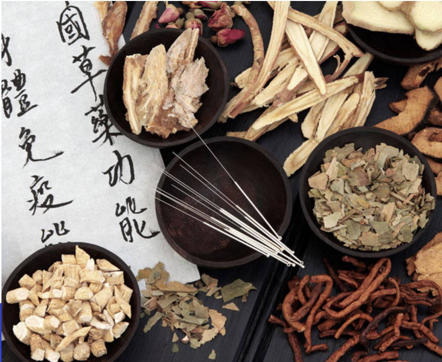 Various dried herbs and acupuncture needles on a textured surface with Chinese text.