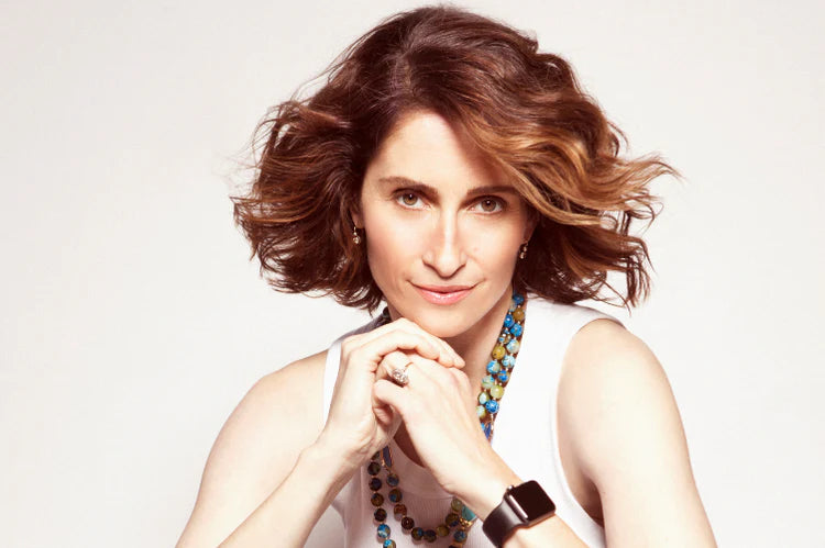 An image featuring Dr. Barbara Paldus, PhD, the founder of our company, posing against a cream-colored background.